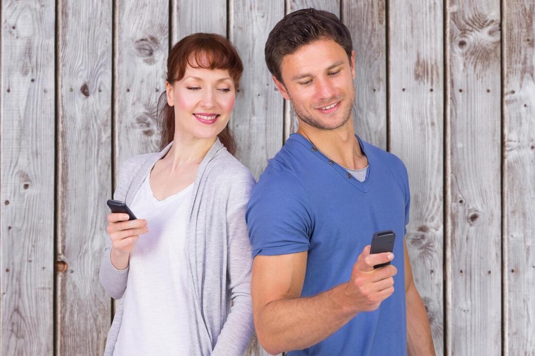 man and woman using a phone